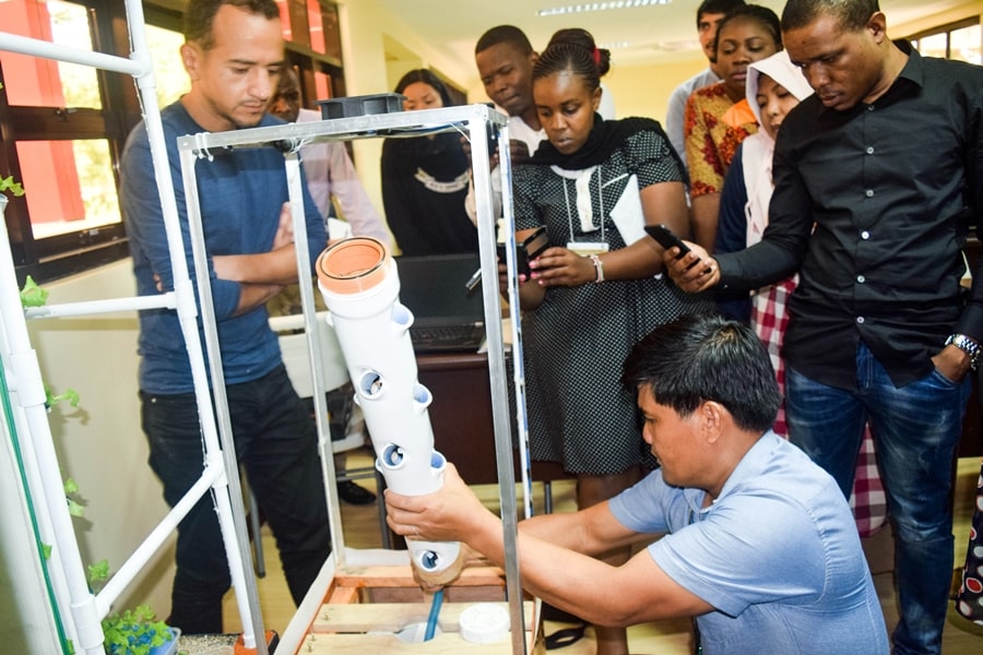 Engr. Christopher S. Pascual, Instructor at the College of Engineering, CLSU, demonstrating the assembly of an indoor vertical tower during Module 2: Vertical and Urban Farming