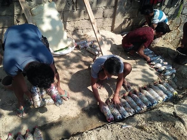 Learners of special prize winner Baay National High School reuse plastic bottles in a construction project