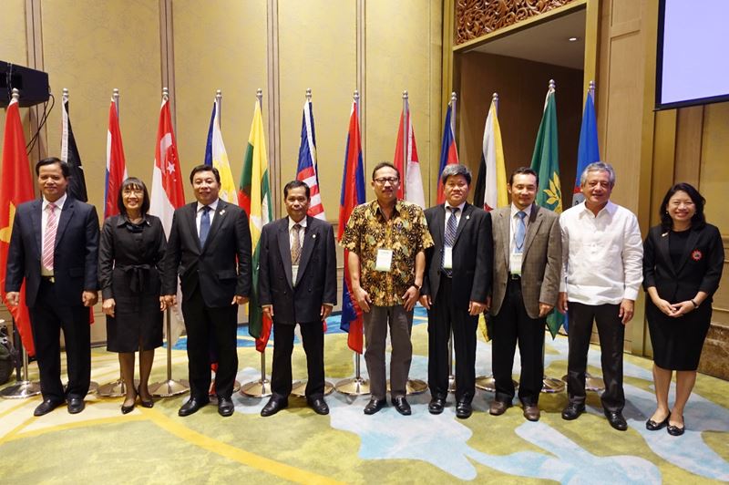 SEARCA GB members stood behind their country flags. From left to right: Dr. Tran Van Dien, Rector of the Thai Nguyen University of Agriculture and Forestry, Vietnam; Mrs. Kanittha Duangpattra representing Dr. Sathit Puttachaiyong, President of Rajamangala University of Technology Krungthep, Thailand; Dr. Fernando C. Sanchez, Jr., Chancellor of the University of the Philippines Los Baños (UPLB) and Chair of the 64th GBM; Dr. Somphong Chanthavong, Acting Dean of Agriculture and Environment at Savannakhet University, Lao PDR; Dr. Ocky Karna Radjasa, Director, Strengthening Research and Development, Ministry of Research, Technology, and Higher Education, Indonesia; Dr. Ngo Bunthan, Rector of the Royal University of Agriculture (RUA), Cambodia; Dr. Haji Mohd Zamri Bin Haji Sabli, Assistant Director of the Institute of Brunei Technical Education, Ministry of Education, Brunei Darussalam; Dr. Gil C. Saguiguit, Jr., SEARCA Director, and Dr. Tinsiri Siribodhi, SEAMES Deputy Director for Administration and Communication, both ex-officio members of the SEARCA GBM.